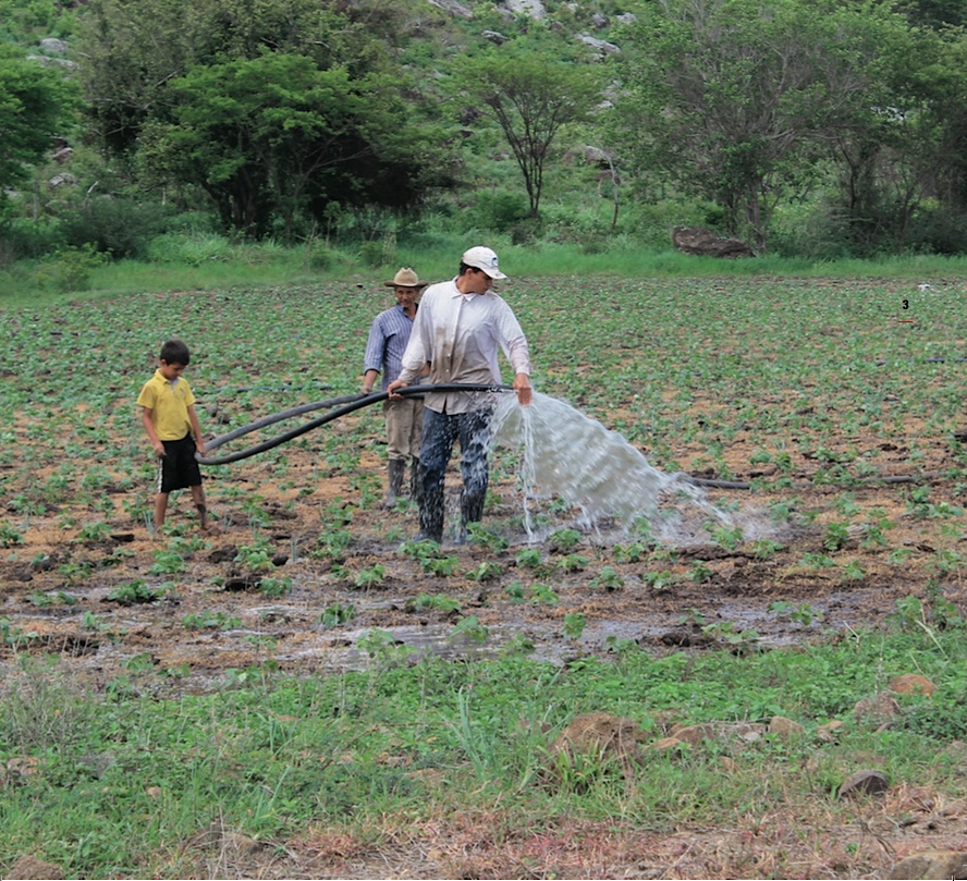 A rural family watering their crops